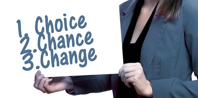 A woman holds a sign saying "Choice 2 Change" - representing career opportunities.