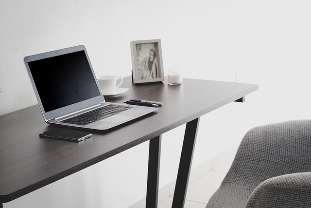 A laptop on a desk in front of a chair. Types of Counselling Courses